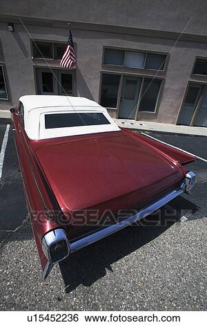 Stock Photograph - "Vintage Cadilac and US Flag parked in front of Saddle Shop, Oak View, California, USA". Fotosearch