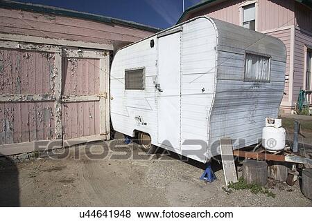 Stock Photo - "White beatup trailer parked in front of pink garage, Ventura, California, USA". Fotosearch
