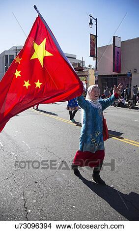 Picture - "Woman displays Chinese flag at Chinese New Year parade, 2014, Year of the Horse, Los Angeles, California, USA". Fotosearch