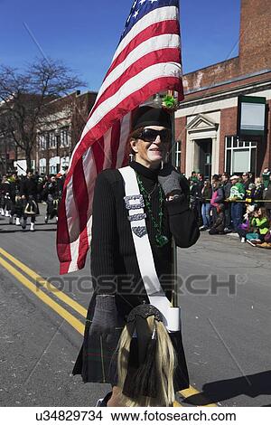 "Woman marches with US Flag, St. Patrick's Day Parade, 2014, South Boston, Massachusetts, USA" View Large Photo Image Picture - "Woman marches with US Flag, St. Patrick's Day Parade, 2014, South Boston, Massachusetts, USA". Fotosearch