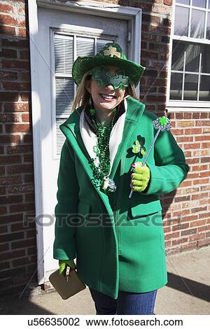 Stock Image - "Young woman in green, St. Patrick's Day Parade, 2014, South Boston, Massachusetts, USA". Fotosearch