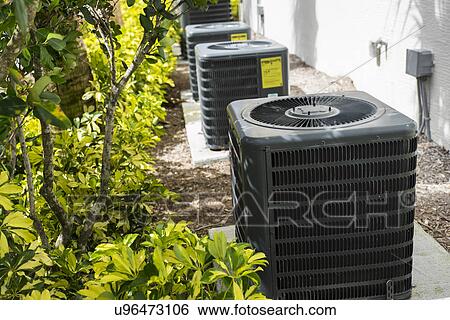 Stock Photograph - Air conditioning unit in garden. Fotosearch