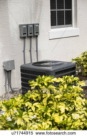 Stock Photography - Air conditioning unit in garden. Fotosearch