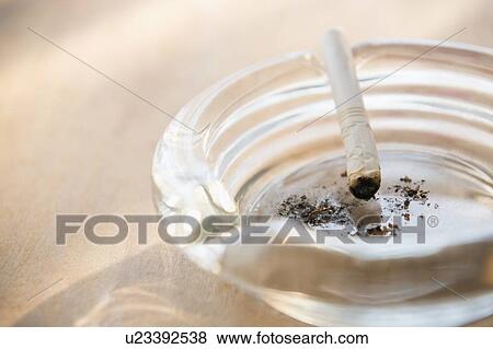 Ashtray with burnt cigarette View Large Photo Image Stock Photo - Ashtray with burnt cigarette. Fotosearch