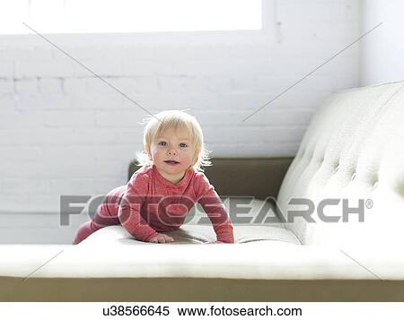 Baby boy (2-3) crawling on sofa View Large Photo Image Stock Photography - Baby boy (2-3) crawling on sofa. Fotosearch