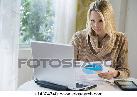 Blond woman working from home View Large Photo Image Stock Image - Blond woman working from home. Fotosearch