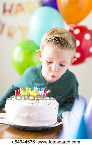 Boy (2-3) blowing out candles View Large Photo Image Stock Photograph - Boy (2-3) blowing out candles. Fotosearch