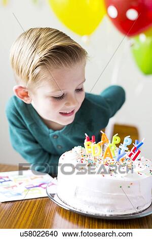 Boy (2-3) looking at birthday cake View Large Photo Image Stock Image - Boy (2-3) looking at birthday cake. Fotosearch