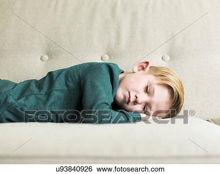 Boy (2-3) sleeping on sofa View Large Photo Image Stock Photograph - Boy (2-3) sleeping on sofa. Fotosearch