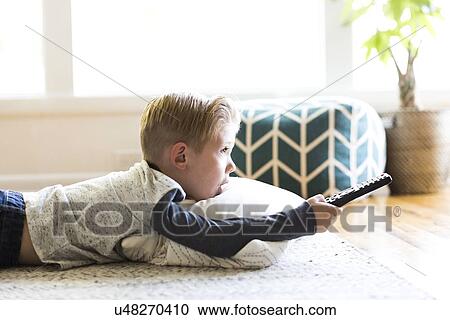 Boy (4-5) watching tv in living room View Large Photo Image Stock Image - Boy (4-5) watching tv in living room. Fotosearch
