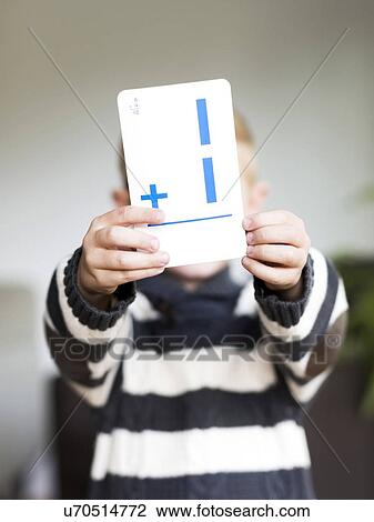 Boy (6-7) holding math card View Large Photo Image Stock Image - Boy (6-7) holding math card. Fotosearch