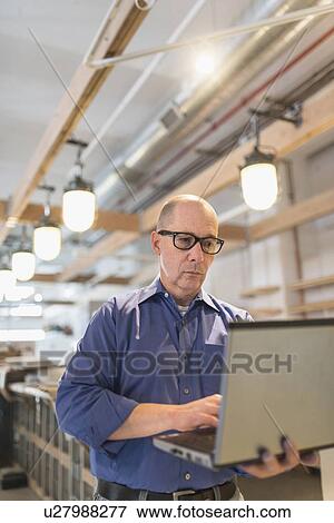 Business owner working with laptop View Large Photo Image Stock Photo - Business owner working with laptop. Fotosearch