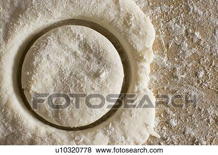 Stock Photo - Circle cut out from fresh dough. Fotosearch