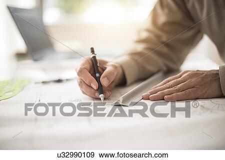 Close up of architect's hands drawing on blueprint View Large Photo Image Stock Photo - Close up of architect's hands drawing on blueprint. Fotosearch