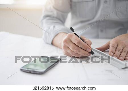 Close up of architect's hands drawing on blueprint View Large Photo Image Stock Photography - Close up of architect's hands drawing on blueprint. Fotosearch