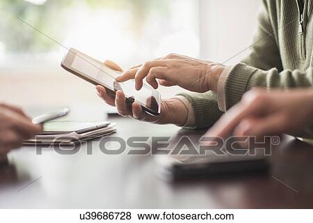 Close up of hands of men and woman working with electronical devices View Large Photo Image Stock Photo - Close up of hands of men and woman working with electronical devices. Fotosearch