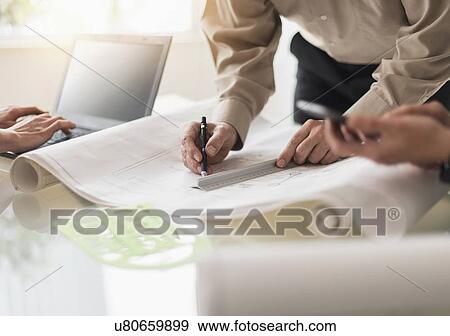 Stock Photo - Close up of hands of men and woman working wt desk. Fotosearch