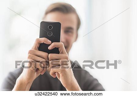 Close-up of man using mobile phone View Large Photo Image Stock Image - Close-up of man using mobile phone. Fotosearch