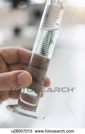Close up of man's hand holding test tube with liquid View Large Photo Image Stock Photography - Close up of man's hand holding test tube with liquid. Fotosearch