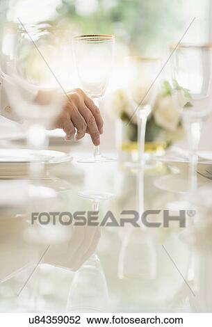 Close up of man's hand setting place in restaurant View Large Photo Image Stock Image - Close up of man's hand setting place in restaurant. Fotosearch