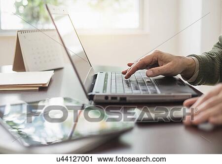 Close up of man's hands using laptop at desk View Large Photo Image Stock Image - Close up of man's hands using laptop at desk. Fotosearch