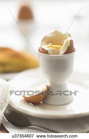 Close up of soft boiled egg in egg cup View Large Photo Image Stock Photo - Close up of soft boiled egg in egg cup. Fotosearch