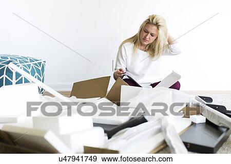 Confused woman reading instruction manual View Large Photo Image Stock Photo - Confused woman reading instruction manual. Fotosearch