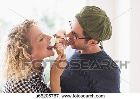 Couple eating ice cream together View Large Photo Image Stock Photo - Couple eating ice cream together. Fotosearch