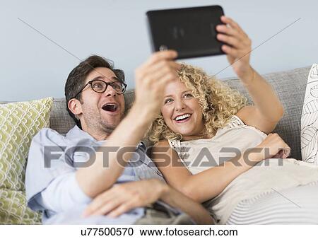 Couple using tablet pc View Large Photo Image Stock Image - Couple using tablet pc. Fotosearch