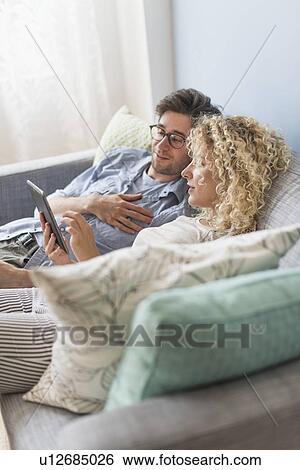 Couple using tablet pc View Large Photo Image Stock Photograph - Couple using tablet pc. Fotosearch