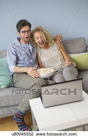 Couple watching movies on laptop View Large Photo Image Stock Image - Couple watching movies on laptop. Fotosearch