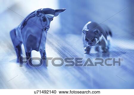 Stock Image - Digital composite with ceramic animals and financial newspaper. Fotosearch