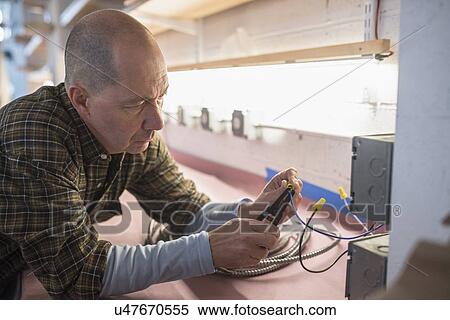 Stock Photography - Electrician fixing wires. Fotosearch