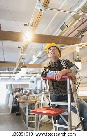 Electrician standing on step ladder View Large Photo Image Stock Image - Electrician standing on step ladder. Fotosearch