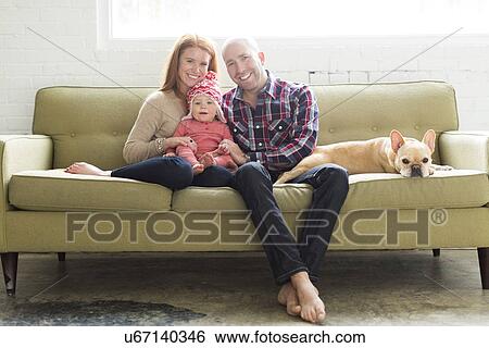 Family with baby son (2-3) and pug on sofa View Large Photo Image Stock Photograph - Family with baby son (2-3) and pug on sofa. Fotosearch