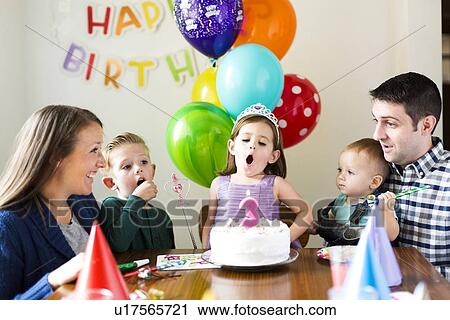 Stock Image - "Family with three children (2-3, 4-5) celebrating birthday". Fotosearch