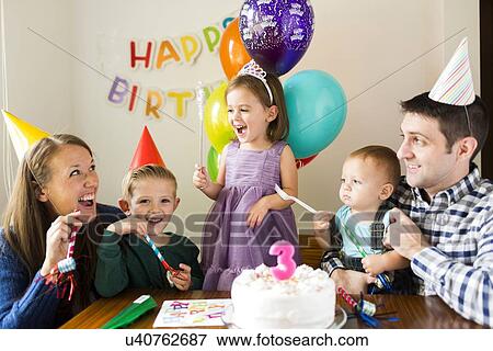 Stock Photo - "Family with three children (2-3, 4-5) celebrating birthday". Fotosearch