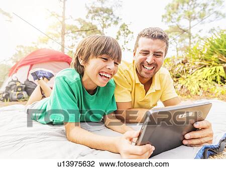 Father and son (12-13) camping View Large Photo Image Stock Image - Father and son (12-13) camping. Fotosearch