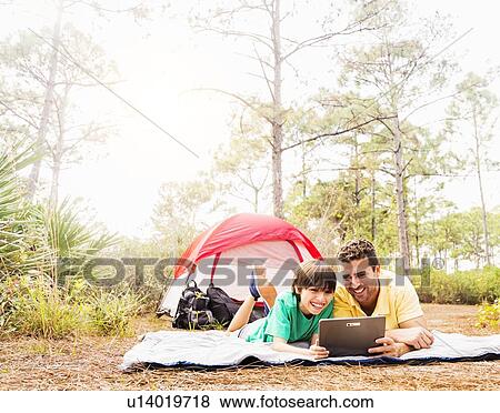 Father and son (12-13) camping View Large Photo Image Stock Photo - Father and son (12-13) camping. Fotosearch