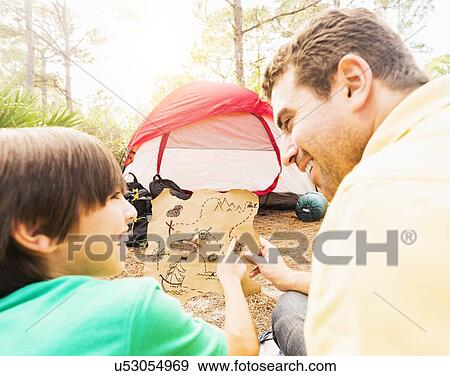 Father and son (12-13) camping View Large Photo Image Stock Photo - Father and son (12-13) camping. Fotosearch