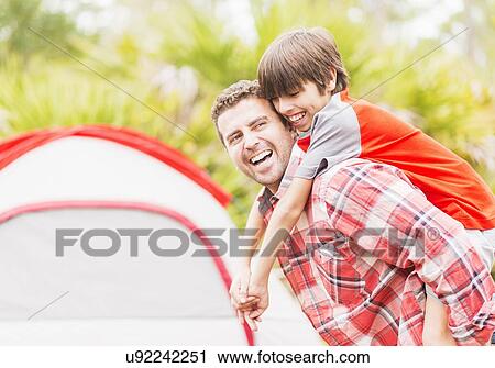 Father and son (12-13) piggy back View Large Photo Image Stock Image - Father and son (12-13) piggy back . Fotosearch