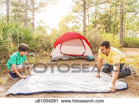 Father and son (12-13) preparing sleeping bag for camping View Large Photo Image Stock Image - Father and son (12-13) preparing sleeping bag for camping. Fotosearch