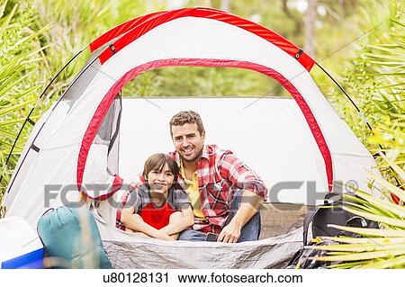 Father and son (12-13) sitting in tent View Large Photo Image Stock Image - Father and son (12-13) sitting in tent. Fotosearch