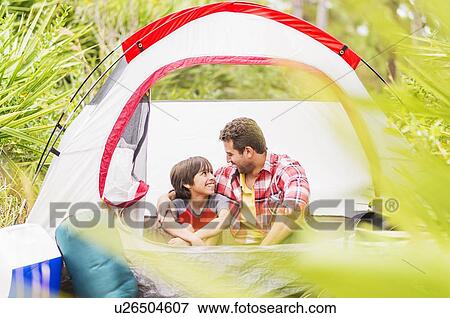 Father and son (12-13) sitting in tent View Large Photo Image Stock Photo - Father and son (12-13) sitting in tent. Fotosearch