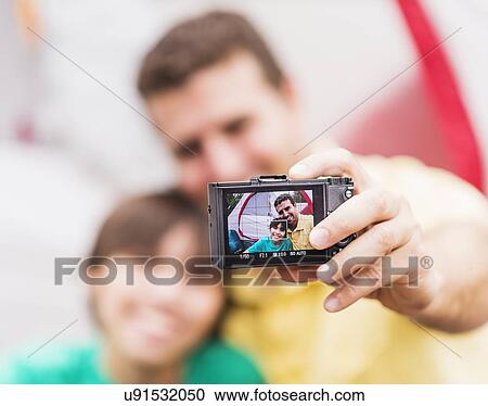 Father and son (12-13) taking selfie in front of tent View Large Photo Image Stock Image - Father and son (12-13) taking selfie in front of tent. Fotosearch