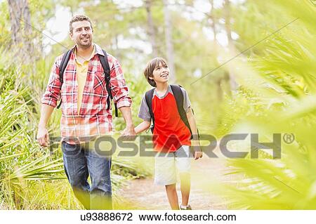 Father and son (12-13) walking in forest View Large Photo Image Stock Image - Father and son (12-13) walking in forest. Fotosearch