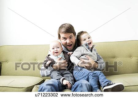 Father embracing two sons (6-11 months and 2-3 years) View Large Photo Image Stock Image - Father embracing two sons (6-11 months and 2-3 years). Fotosearch