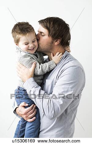Stock Photo - Father kissing son (2-3). Fotosearch