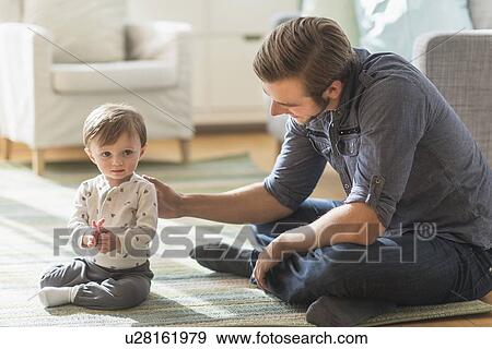 Father sitting on floor with little son (2-3 years) View Large Photo Image Stock Photo - Father sitting on floor with little son (2-3 years). Fotosearch