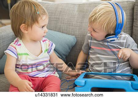 Friends (2-3) sharing digital tablet View Large Photo Image Stock Image - Friends (2-3) sharing digital tablet. Fotosearch